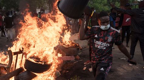 Police fire tear gas and protestors burn vehicles near home of Senegal’s main opposition leader