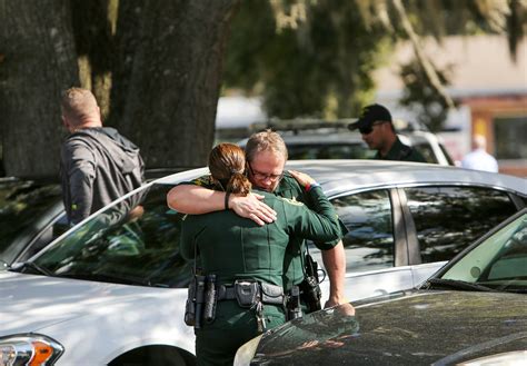 Police searching for gunmen accused of shooting two Orlando officers