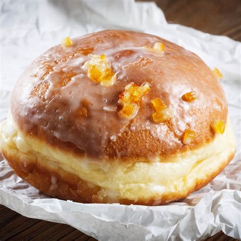 Polish donut. Gather the ingredients. In a medium saucepan, warm the milk and add butter until it has melted. In a large bowl, add salt, sugar, and nutmeg. Pour in the milk and melted butter mix. Stir and set aside until it's lukewarm. When the bowl's contents are lukewarm, mix in beaten eggs and yeast. Add 3 cups of flour. 