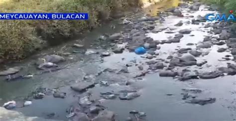 Polluted Bulacan waterway stinks, turns different colors