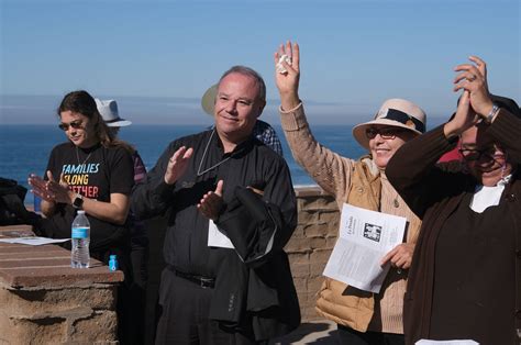 Posada participants gather on both sides of border fence