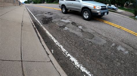 Potholes creating dangerous situation outside Lakewood motorcycle shop