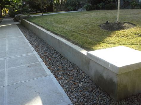 Poured concrete retaining wall. Concrete Retaining Wall. Concrete retaining walls cost $10 to $100 per square face foot (or the square feet of the face of the wall). You can choose from poured, split-face block, or CMU (cinder block). You may also use veneers on poured and cinder walls, but the split-face look comes with a rock-like texture and various colors. 