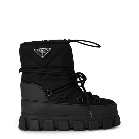 Prada snow boots. Shearling après ski booties. Kr 15.400. Made of leather or embellished with technical fabric inserts, Prada men's boots stand out for their innovative designs and fine craftsmanship. Prada. 