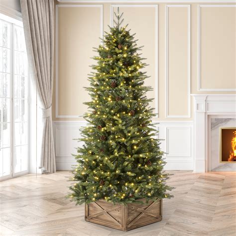 Pick compact Christmas trees with modern styling to extend your Christmas decorating themes into bedrooms and utility spaces, such as large laundry rooms or mudrooms. Create a fun aesthetic by picking Christmas trees pre-lit with vibrant lighting colors, or uphold a more sedate design by adding soft, simple white lights or even no lights at all.