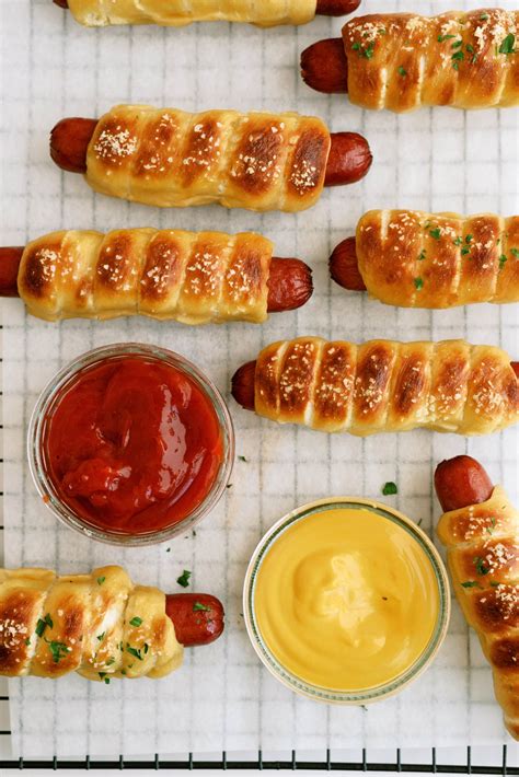 Pretzel dog. May 26, 2021 · Place 2 wrapped pretzel dogs into the water for about 30 seconds. Remove with slotted spoon to a cooling rack. Repeat until all pretzel dogs are boiled. Place boiled pretzel dogs on a sprayed baking sheet. Combine egg and water and mix well. Brush pretzel dogs with egg wash and sprinkle with salt. 