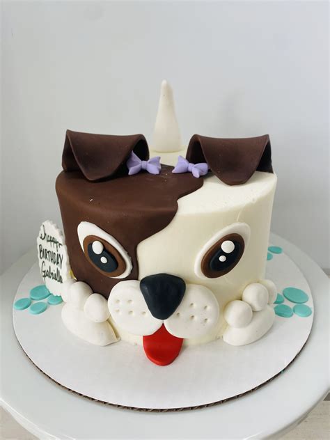 Puppy cake. First, I frosted a 6", two layer cake with vanilla buttercream. (We used our Classic Vanilla Buttercream recipe.) Next, I tinted some of my fondant with ivory coloring, rolled it out on a lightly greased countertop, and cut out a 3 … 
