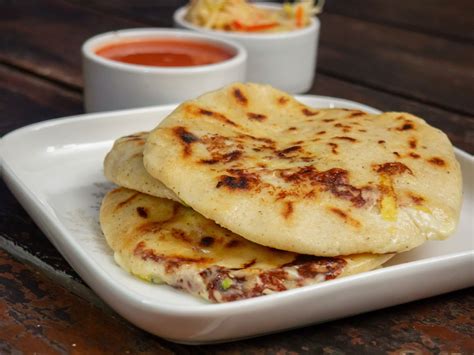Pupusas colfax. Instructions. Heat a comal or griddle. In a large bowl combine the flours or masa harina, and salt. Make a well in the center and pour oil and water. Stir until a wet dough is formed. The dough will not have elasticity like that of other breads. Divide the dough into even sizes. Make a flat disc between your palms. 