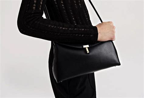 Quiet luxury handbags. At the end of last year, Toteme unveiled its foray into luxury handbags and predictably, it's starting to gain serious momentum. The minimal Toteme T-Lock bag is made from a beautifully soft leather that comes in black, tan, a mole grey and a milky white. Featuring a curved top flap, dual straps (short and long), and an understated T-shaped ... 