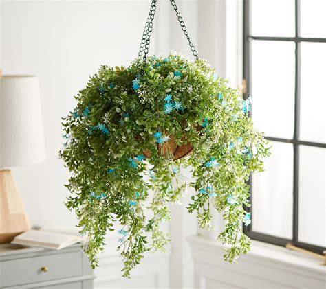 Step-by-step: how to make an artificial hanging basket: Choose a suitable basket and weigh it down. Secure your oasis foam with wire. Poke artificial flowers & foliage into the oasis foam. Add finishing touches and final tweaks. 1. Choose a suitable basket and weigh it down. In the video above, we use a 30cm (w) x 15cm (h) wicker basket, but .... 
