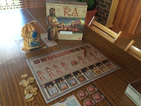 Ra board game. Ra is an Egyptian-themed boardgame from the prolific designer Knizia that uses one of his favorite mechanics—the single-round auction, also found in earlier games like Medici. 