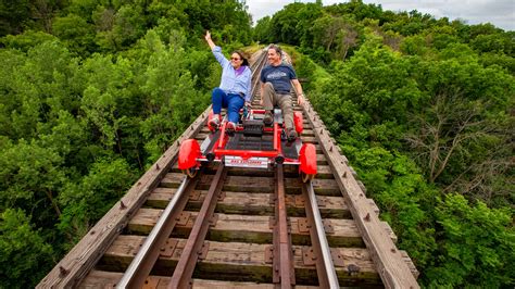 Rail explorers. Jul 28, 2023 · A new, unique tourist attraction in the Commonwealth opened in Versailles this week. Rail Explorers lets folks strap in to a red rail bike and pedal down five miles of train tracks. Kentucky's two-hour trek spans five miles of countryside, stopping at the Young’s High Bridge, which overlooks the Kentucky … 