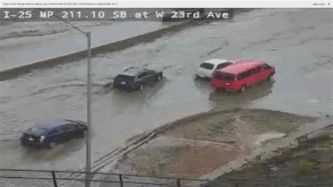 Rain washes mud and debris onto flooded I-25