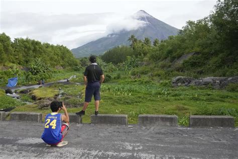 Rains unleashed by typhoon worry thousands of people fleeing restive Philippine volcano