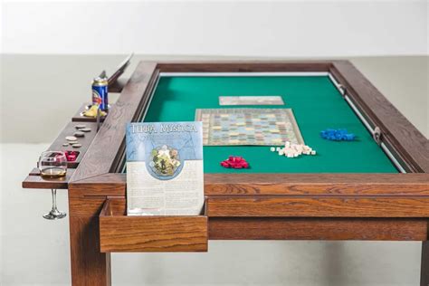 Rathskellers game table. A truly innovative piece of furniture that will become a staple in your everyday life and will perfectly complement your Sunnygeeks table. Comfortable stool with water-resistant & easy to clean fabric; Sliding Storage for 8 drawer toppers; Sliding Storage for 2 Advanced Player Stations; Storage for 9 Drawers/Boards Games or 1 Storage Box 