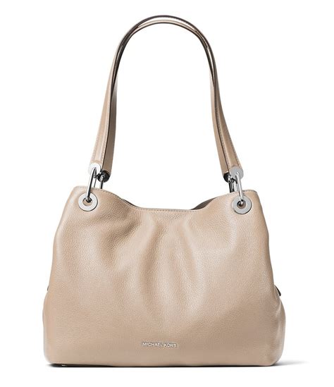 Organized edge meets signature style with this Raven tote from MICHAEL Michael Kors. Outfitted with a three-compartment design, this chic tote is spacious enough for everyday organization and travel-ready looks. 13-1/2"W x 10"H x 5-1/2"D (width is measured across bottom of the handbag) 