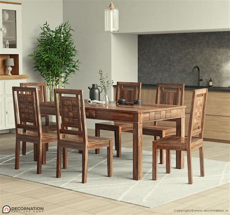 Real wood dining set. This 9-piece dining set elevates the farmhouse style of your dining room. Crafted with solid and engineered wood, this set includes eight dining chairs and one dining table. The wingback chairs feature linen upholstery with diamond button tufting and nailhead trim, while the legs tie in with the walnut finish of the dining table. We love the turned details on the … 