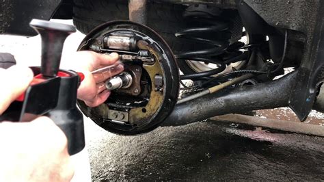 Remove your rear drum, turn the star wheel adjustment until there is some resistance when putting the rear drum back on. Then adjust the bell crank screw so there is about 1mm gap. Re-attach your parking brake and adjust the parking brake adjustments until you have 8-10 clicks in the parking brake.. 