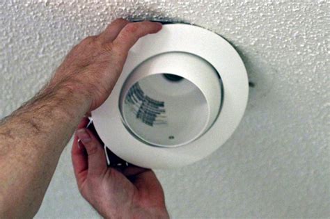 Recessed lighting installation. Mount the Base. Place the base of the fixture over the outlet box, making sure the mounting screws are lined up and properly connected. Twist the base clockwise into place until the heads of the mounting screws are secure. Tighten with a screwdriver as needed to lock all components into place. 4. 