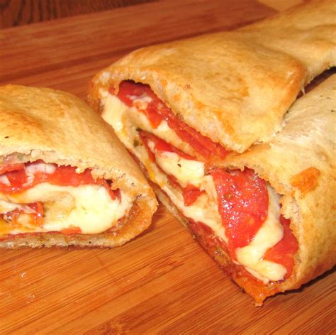 Recipes made with pillsbury pizza dough. 1. Heat oven to 425°F. Spray cookie sheet with cooking spray; sprinkle with cornmeal. Do not unroll dough. Cut roll of dough into 4 equal pieces; shape each piece into a ball. Roll or press each ball of dough into a 5-inch round making edges slightly thicker to form a rim. Place the rounds on the prepared cookie sheet; brush each with oil. 