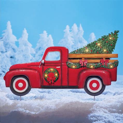 Red truck christmas tree. Product Features: Matte red iron pick-up truck Christmas ornament Features a frosted green pine tree in the truck bed Front of truck has a dcorated wreath attached Can be table mounted or hung This is a fully dimensional unit Recommended for indoor and decorative use Dimensions: 6"H x 12"L x 6.5"W Material(s): iron plastic/nylon 