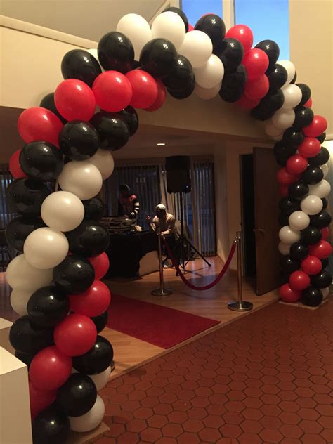 Red white and black balloon arch. Balloon Arches & Columns. Balloon arches bring color to any room, transforming a normally simple room into a vibrant masterpiece. They can frame your head table or go over a doorway. For an especially exciting entrance ask about how we group three arches together to form a magnificent balloon tunnel. Load more. (89 images remaining) 