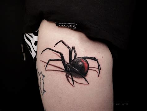Redback spider tattoo on the left thigh.