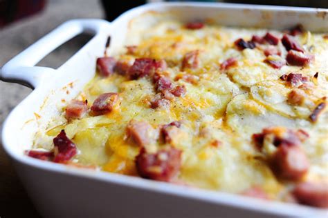 Makes 12 servings. 3 cup diced ham. 1 yellow onion, chopped. 3 lb russet or Yukon Gold potatoes, washed thoroughly. 1/4 cup flour. 2 tbsp butter, plus more for the pan. 1 1/2 cup half-and-half. 1 1/2 cup heavy cream. 1 cup grated cheddar cheese.. 