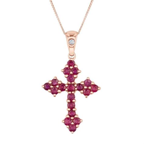 Proudly express your faith with this stunning pendant necklace. Crafted in 10k white gold, this pendant features an ornate cross design that is lined with treated black diamonds and round diamonds. The pendant measures 34mm in length and 23mm in width and comes suspended from an 18 inch box chain.. 