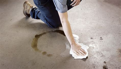 Removal of oil stains from concrete. 3. Scrape away the powder and repeat if necessary. Use a spoon to scrape away the powder or vacuum it up. If oil is still visible on the fabric, add fresh powder to the area and let it sit for 15 minutes. Then, scrape it away with a spoon or vacuum it up. [11] 4. Blot the stain with soapy water or solvent. 