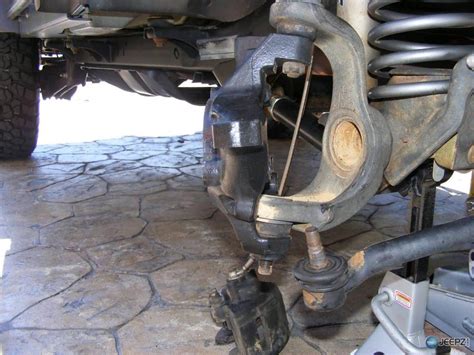 4. Slide the ball joint stud into the steering knuckle. 5. Install the castle nut on the ball joint stud. Use a torque wrench to tighten the castle nut to the manufacturer's specification. 6. Install a new cotter pin (the control arm may come with a replacement) into the castle nut.. 