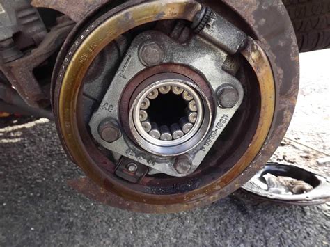 Replace wheel bearing. Disconnect the negative battery cable. Remove the center cap or hub cap from the wheel. Remove the cotter pin and lock cap from the axle nut (if so equipped). Use a breaker bar to loosen the axle nut. Do not remove the nut completely at this time. Use a breaker bar to loosen the wheel lug nuts. 