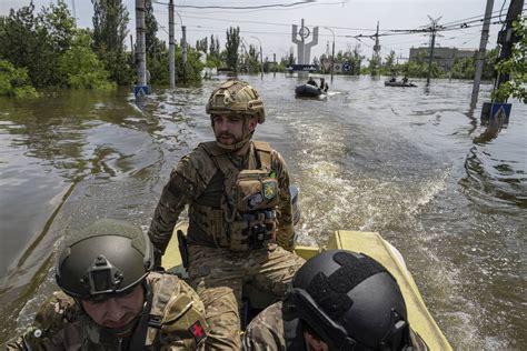 Rescuers are braving snipers as they rush to ferry Ukrainians from Russia-occupied flood zones