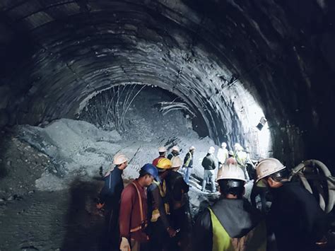 Rescuers dig to reach 40 workers trapped in a tunnel in India