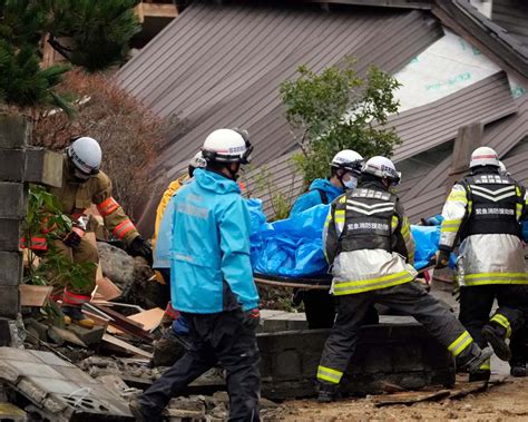 Rescuers race against time in search for survivors in Japan after powerful quakes leave 62 dead