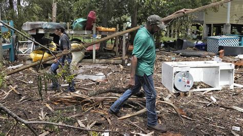 Residents pick through the rubble of lost homes and scattered belongings in Hurricane Idalia’s wake