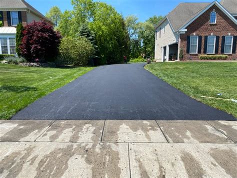 Resurface asphalt driveway. Ideally, an asphalt surface should be seal coated every three to five years. However, if you have recently installed a new asphalt driveway, give it at least 90 days before applying sealant. Sealcoating a freshly poured surface too early may retain oils within the asphalt, resulting in an overly soft or flexible surface. 