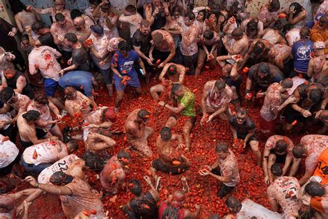 Revelers hurl tomatoes at each other and streets awash in red pulp in Spanish town’s Tomatina party