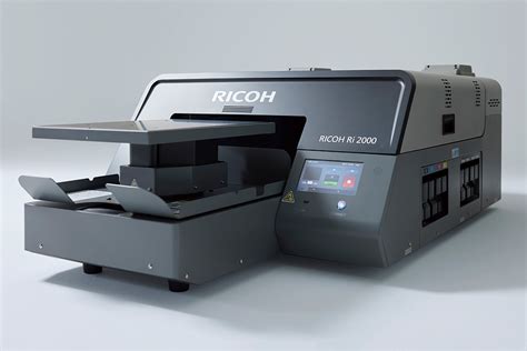 Ricoh ri 2000 price amazon. The new RICOH Ri 100 is a Direct to Garment (DTG) printer for anyone, anywhere. It prints designs and photographs directly onto garments using state-of-the-art inkjet technology. The Ricoh Ri 1000 uses smart technology to print vibrant soft-touch graphics on a wide range of garments and textiles. 