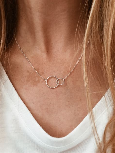 Ring necklace. A duo of interlocking circles adds a modern touch to any look. Proudly inscribed with the year Tiffany was founded, the Tiffany 1837® collection is defined by sleek curves and contours. A duo of interlocking circles adds a modern touch to any look. Sterling silver. Size small. On a 16" chain. 