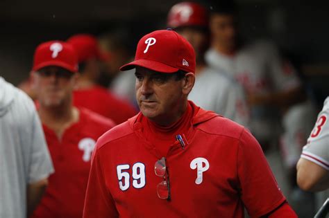 Philadelphia Phillies manager Rob Thomson carries a bat during practice ahead of Game 1 of the baseball NL Championship Series against the San Diego Padres, Monday, Oct. 17, 2022, in San Diego.. 
