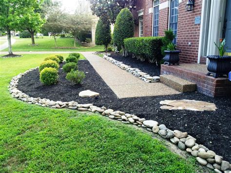Rock mulch. Plant bulbs like lilies and tulips so you can enjoy fresh flowers at the first sight of spring. 2. Front Yard Curb Appeal. Photo: Simone / Adobe Stock. Consider some front yard landscaping ideas with rocks when planning your design. Create a stone path to line flowers and bushes using various-sized rocks and stones. 