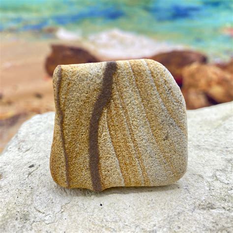 Sandstone. Sandstone is a clastic sedimentary rock comprised of sand-sized particles about .1 to .2 mm in size. It is usually tan, brown, or reddish in color, and often (but not …. 