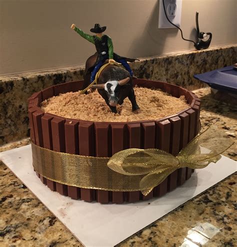 A delicious and beautifully crafted bull riding/rodeo cake made by Simply Sweet Cakes by Erin. Perfect for a cowboy-themed birthday party or any western-themed celebration.