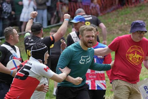 Rolling thunder: Contestants chase cheese wheel down a hill in chaotic UK race