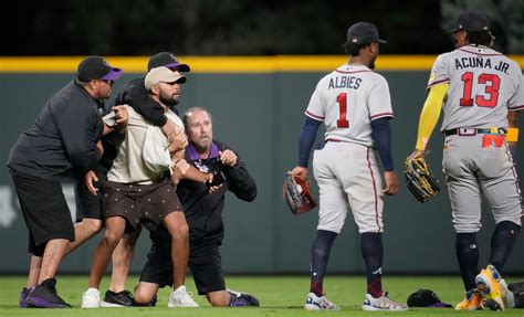 Ronald Acuna Jr. tackled by fan at Coors Field during Rockies-Braves game