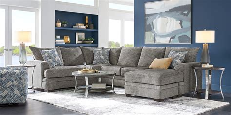 Upholstered with plush chenille fabric in a crisp shade of parchment beige, this sectional features tight slip over arms, reversible seat cushions and sumptuous seating perfect for lounging. Included accent pillows offer a colorful splash of blue, gray and beige. 91% Polyester, 9% Polyurethane. SKU 1071634P. . 