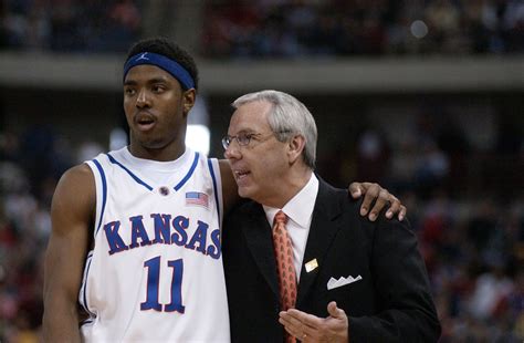 Roy williams kansas. 1) Roy Williams brought most of the Dean Smith system with him to Kansas and has kept it largely intact. 2) Saw a clinic video of Williams discussing his secondary break. After the corner comes up and sets the backscreen for the post trailer, they hit that screener with the pass. 4 then cross screens for 5 and ducks in. 