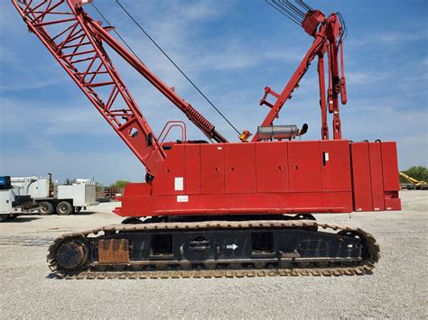 Used 2022 Tadano GR1300XL for sale or rent at our dealership location in Swisher, Iowa. - GVW: 158100 Lbs - Boom: Six Section Boom w/ Pinning System; Round Box Construction 40.0'-183.7' - Jib: 2 Stage Bifold Offset Jib 33.8' or 59.1' - Anti Two Block - Main Hoist: 3/4" Cable - Aux Hoist: 3/4" Cable - Blocks/Balls: 7.9 Ton Ball 100 Ton 7 Sheaves Hook Block …. 