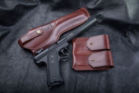 Mark IV™ & Mark III™ 5.5" Barrel Triple K Belt Holster, LH. Leather Holsters fits Ruger® Mark I, Mark II™, Mark III™ and Mark IV™ Pistols. Ruger logo stamped on front of holster with walnut oil finish. Made in the USA by Triple K. Left-Handed. DOES NOT FIT 22/45™ PISTOLS.